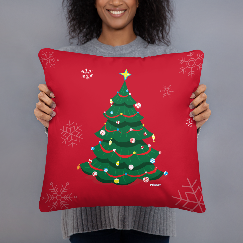 Christmas tree pillow being help by a woman shows that it is a medium sized square pillow